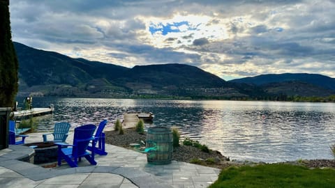 Beautiful outdoor area at lake level with BBQ, fire pit and private dock.