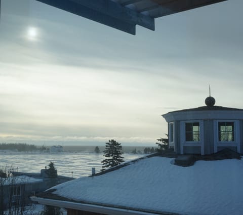 View from the living room to the outer harbor and Coast Guard Station in winter.