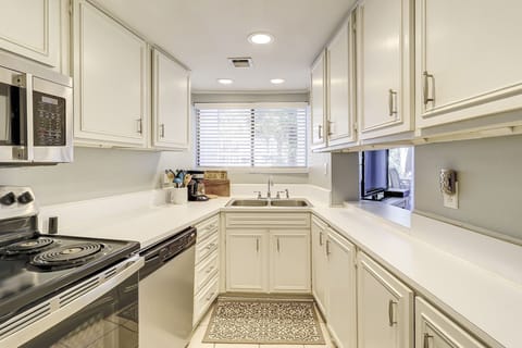Kitchen area sticked with all the necessary pots, pans and dishes.