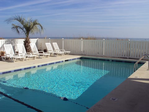 ocean side pool with lounge chairs