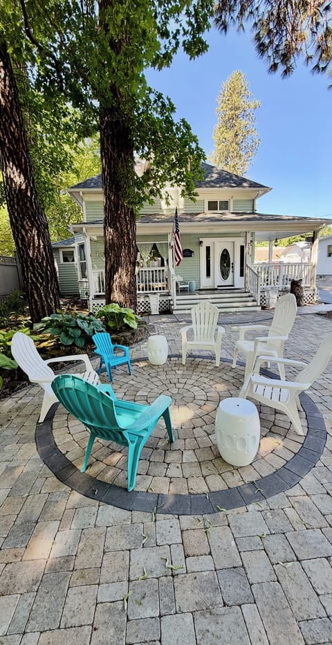 Front yard with new pavers and outdoor seating under the trees Summer 2025