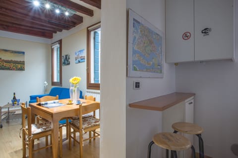 The table in the living room together with a kitchen corner