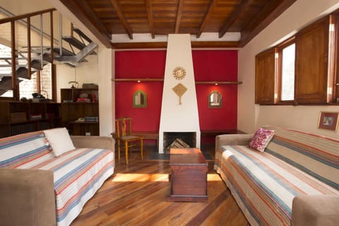 Living room with wooden beans, great view to the mountains and a cozy fireplace