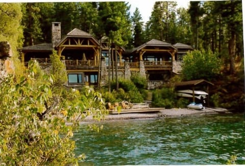 View of property (rental is lower level separate apartment), beach and deck area