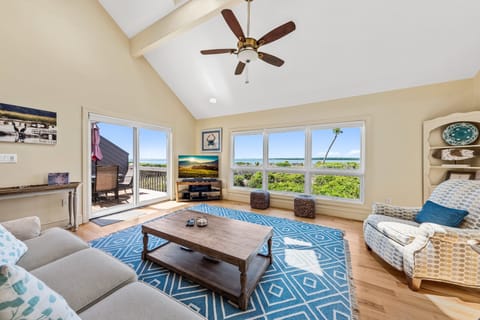 Sliding doors lead out to the side deck.  Vaulted ceilings add to the spacious feeling of this room
