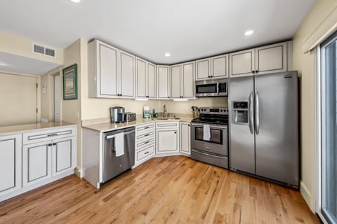 Highlights include custom cabinets, stainless appliances & access to the deck.