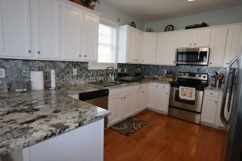 Newly updated kitchen with granet and sea glass backsplash