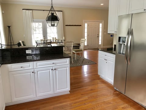 The open kitchen features stainless steel appliances and plenty of counter space.