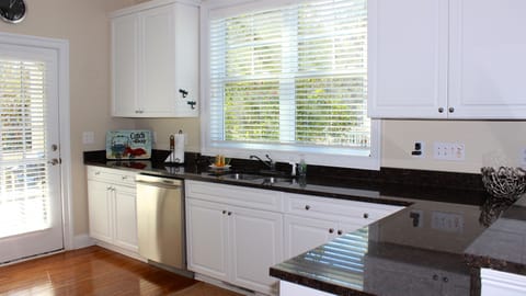 Bright and sunny, there is a small deck with a gas grill.