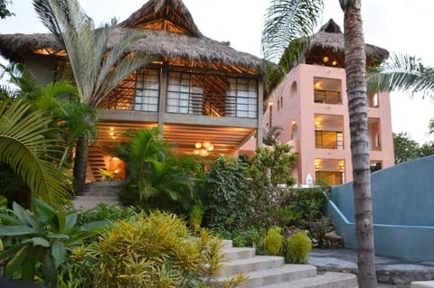 View of the house and its garden at dusk