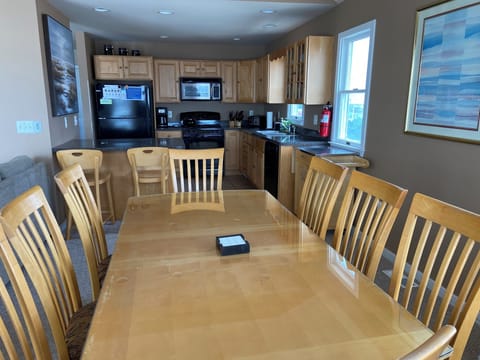 Modern open kitchen / dining room with seating for 14.
