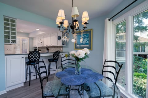 Two counter stools buffer the dining are from the kitchen