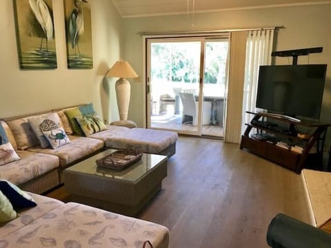 There is plenty of seating for conversation or TV viewing. Sliding doors lead to the large screened in patio.