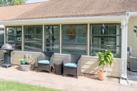 Enclosed back porch and outdoor grill.