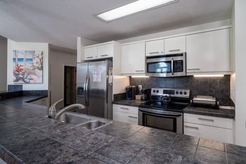 Even the most discerning chef will be impressed with this kitchen.  Stainless steel appliances, white cabinets,