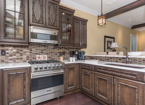 Sub Zero refrigerator and freezer with custom cabinets featured in the kitchen.