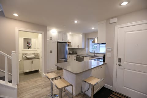 Breakfast area with three bar stools.  Powder room off the kitchen.