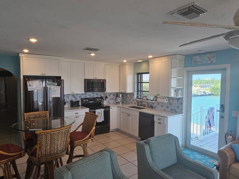 Updated, furnished kitchen with stainless, quartz and backsplash.  Open concept.