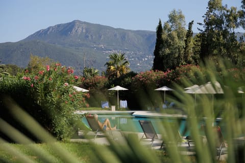 Seasonal outdoor pool, open 10:00 AM to 8:00 PM, pool umbrellas