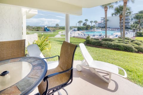 Patio - Pool view patio features a table with seating for four and an electric grill for outdoor barbequing. Perfect spot to relax and unwind!
