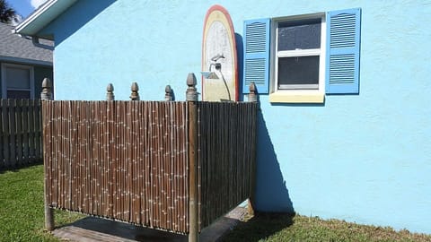 Outside enclosed rain shower on surfboard. 