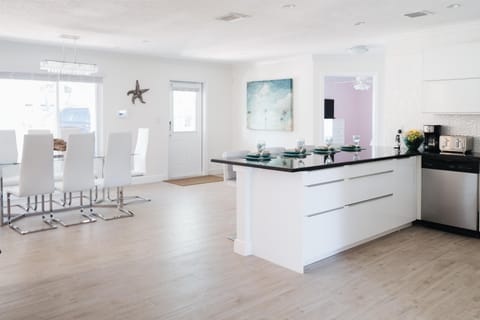 Kitchen bar seating for 4 creates an architectural flow into the dinning room.