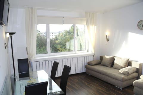 Apartment, 1 Bedroom, Balcony | Living room | Flat-screen TV