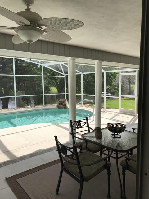 Screened pool with table & chairs and grill