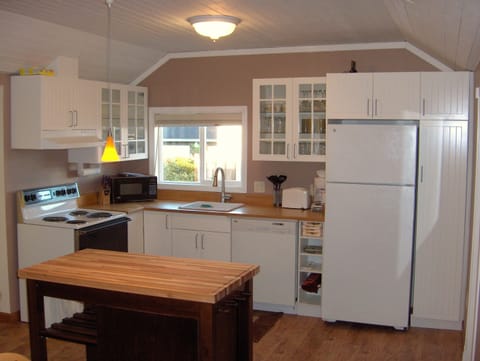 Kitchen w microwave, stove, fridge, toaster, dishwasher and plenty of pots/pan