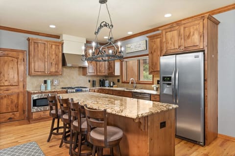 Gourmet kitchen open to great room, dining area, and breakfast table