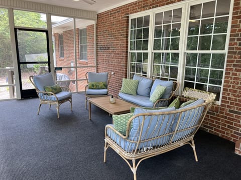 View of the screened in porch and walkway that leads to the dock