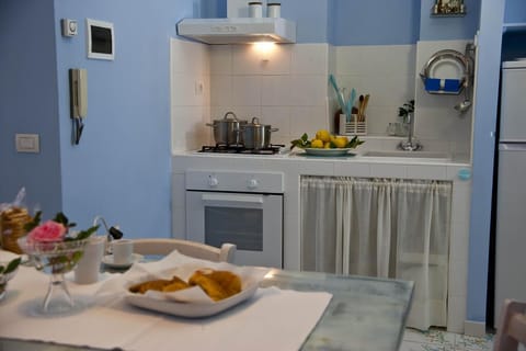 Apartment, 1 Bedroom | Private kitchen | Fridge, stovetop, highchair, cookware/dishes/utensils