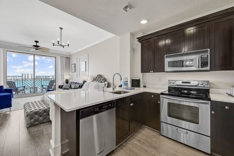 Open kitchen with 3 bar stools for in-suite dining.