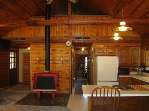 Great room with vaulted ceiling, loft, and wood burning fireplace