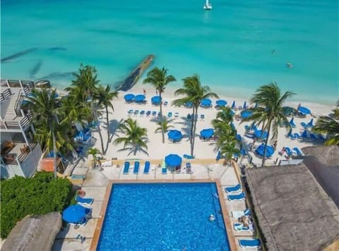 Beachfront Nautibeach condo exterior view – direct beach access from the grounds.