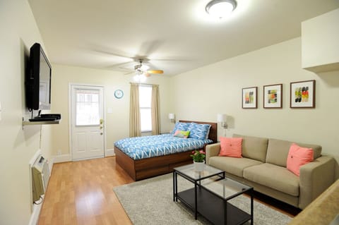 Open floor plan with queen bed, couch, and large 42 inch flat screen tv.