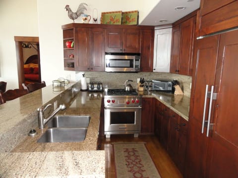 Kitchen in larkspur ski home is open to great room. Wolf range & Subzero fridge.
