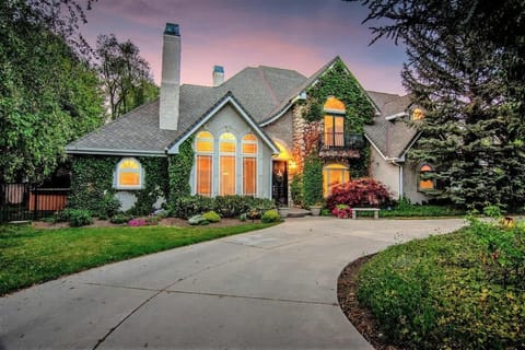 Chateau with river rock facade, gardens and circular driveway