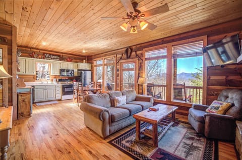 A Glimpse of the Living Room - 3-Level Cabin with Hot Tub, Outdoor Fire Pit, Pool Table and Mountain Views!