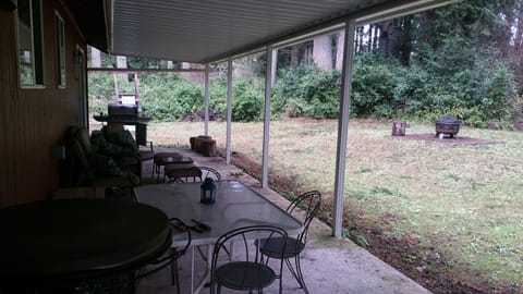 Back covered patio with fire pit and grill.