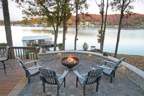 Viewing out into the cove from lower level stone patio. Mature trees w/ shade.