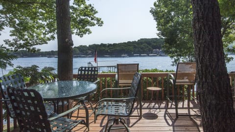 Viewing out into the cove from the large lower level deck. Mature trees w/ shade