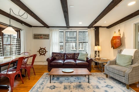 Living Room: Bright space with nautical charm, leather couch, and dining for four! Perfect for relaxing!