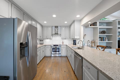 Open kitchen with 3 barstools.