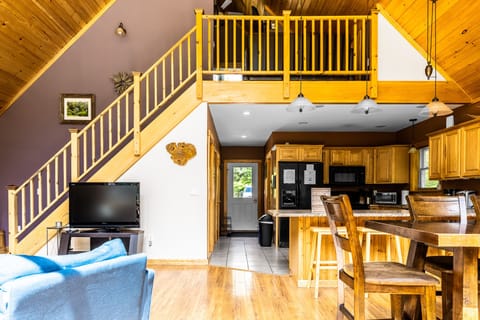 Living room and dining area with stairs going up to the upstairs loft.