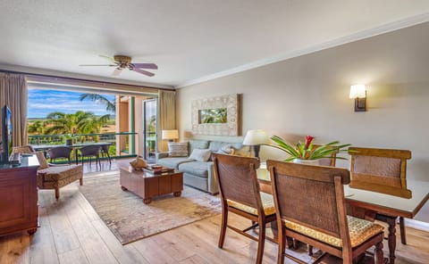 Living room and dinning area - Bright and comfortable living area with plush seating and a large flat-screen TV