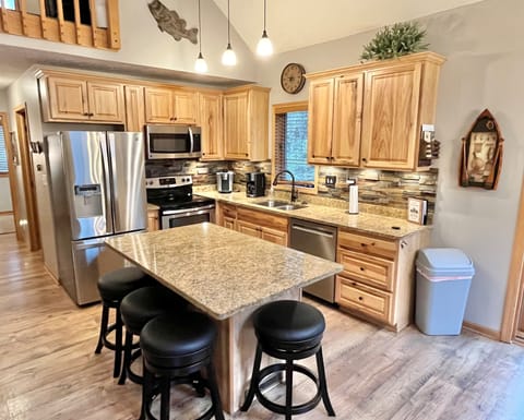 Renovated open kitchen, granite countertops & seating for up to 14 to eat.   