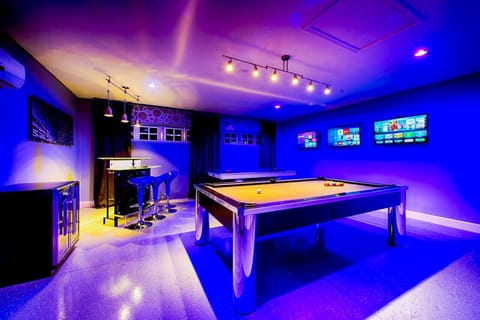 Game Room: Dive into fun with vibrant colors, pool tables, and sleek bar seating for epic nights!