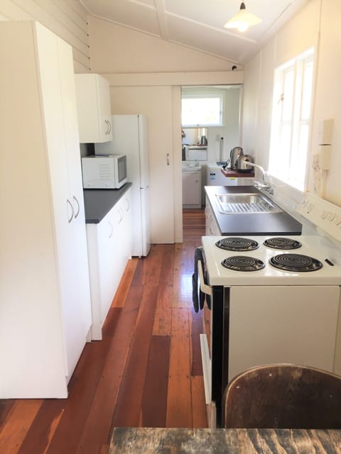 Kitchen/ dining looking towards bathroom/ laundry area.