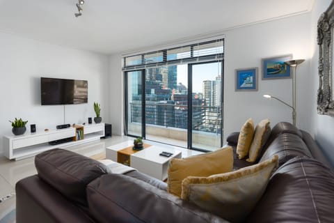 Comfort Condo, Balcony, City View | Living area | Flat-screen TV